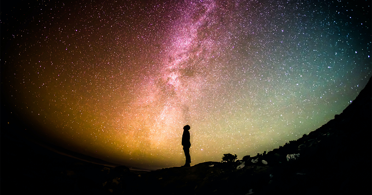 Are we alone in the universe? Person gazing at the night sky